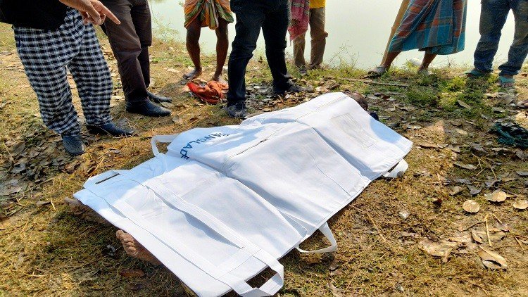 মাঠে কাদার মধ্যে পড়ে আছে শিক্ষকের লাশ
